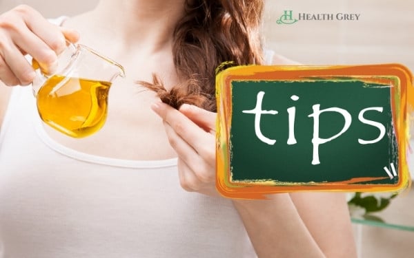 Tips to grow hair fast, a cup of oil girl applying on hair