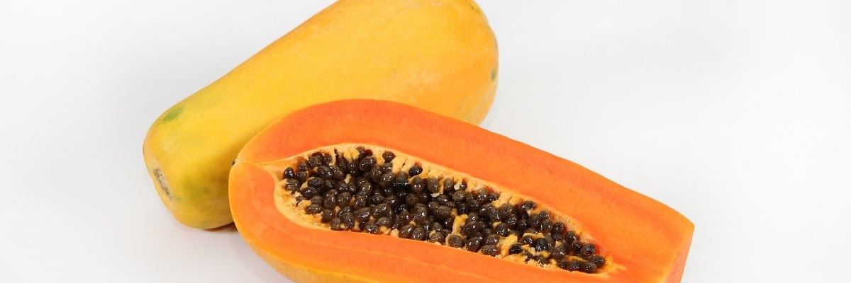 Papaya full and half cut with seeds