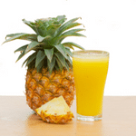 Pineapple juice in a glass and Pineapple with a slice