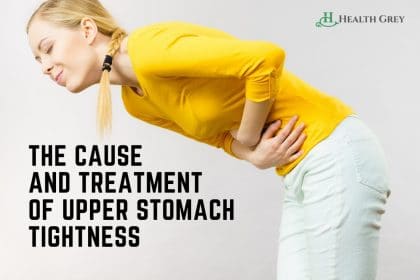 A girl tight feeling in upper stomach, wearing yellow shirt and hands on stomach