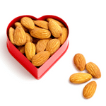 Raw almonds in red heart shape box