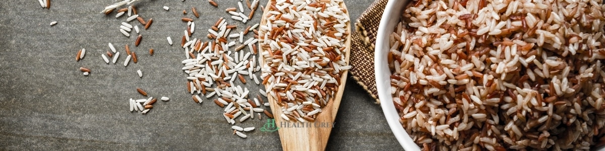 Brown rice in a bowl and serving spoon